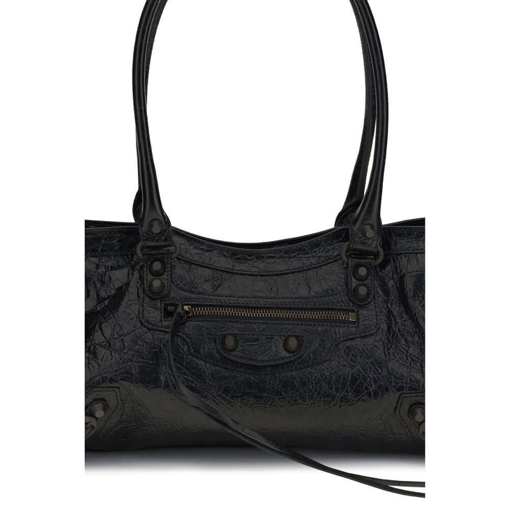 Black leather shoulder bag with double handles and zip pocket detail, perfect for urban style.