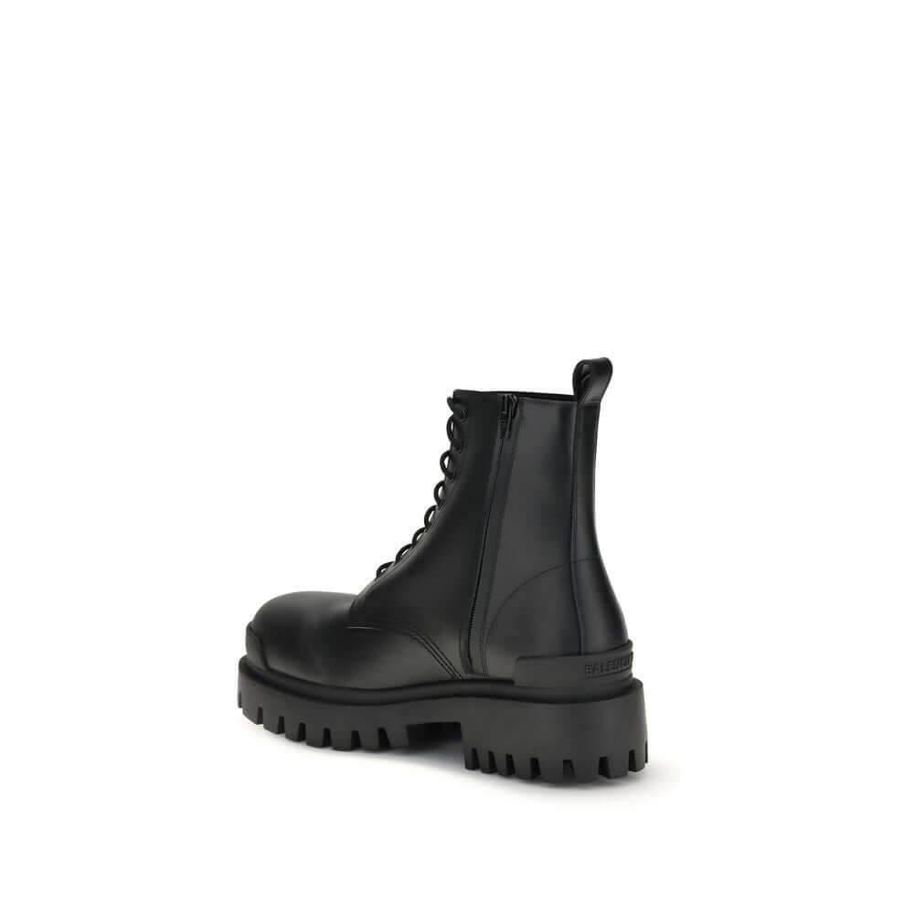 Black calf leather lace-up boots with a rounded toe and tread sole, showcasing modern design and craftsmanship.