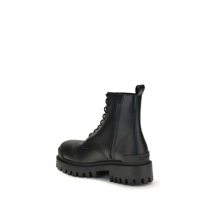 Black calf leather lace-up boots with a rounded toe and tread sole, showcasing modern design and craftsmanship.